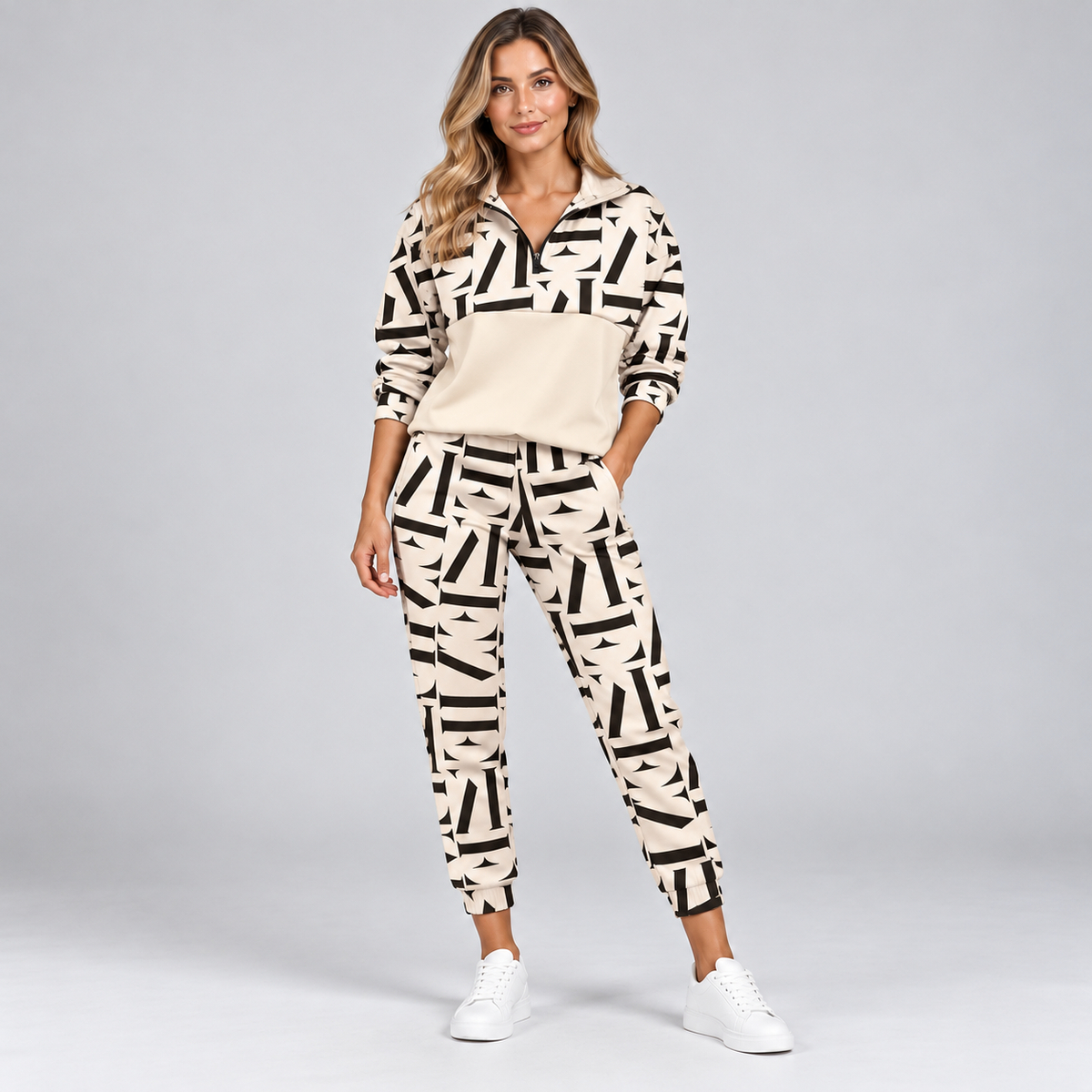 Women's half-zip tracksuit set in beige with black geometric print, front view