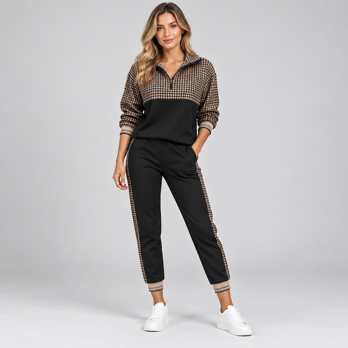 Women's half-zip tracksuit set in black with houndstooth panel and jogger pants, front view